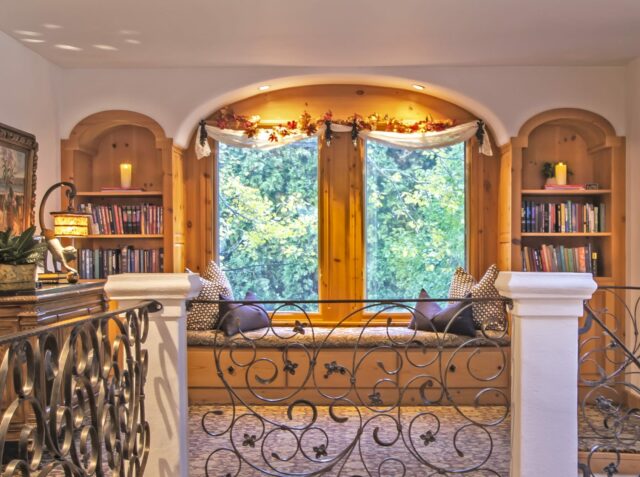 Window seat with pillows and bookshelves